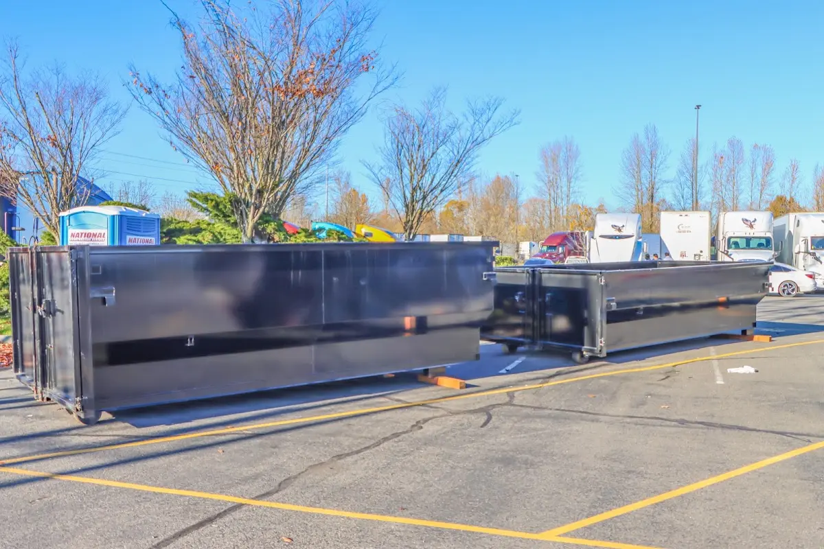 Professional dumpster rental service with roll-off container on residential driveway in Bartlesville